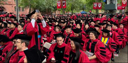 Graduates gather to attend the commencement ceremony at Harvard University in Cambridge, Massachusetts, on May 29, 2025. US President Donald Trump is furious at Harvard for rejecting his istration's push for oversight on issions and hiring, amid the president's claims the school is a hotbed of anti-Semitism and 